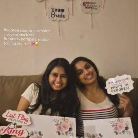 a couple of women holding bridesmaid hampers